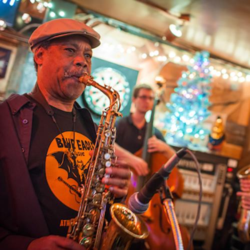 Musicians play saxophone and other instruments during a live performance at Tony's Tavern.