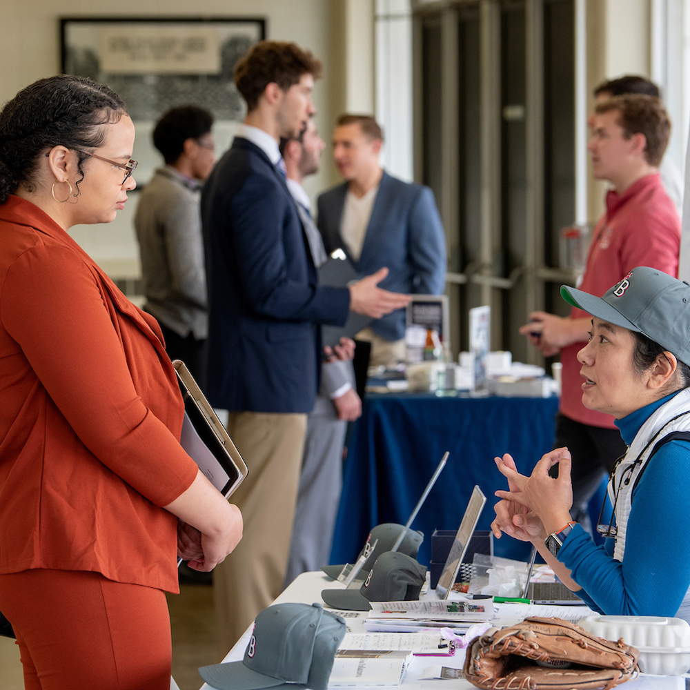 Two women checking in at a business conference