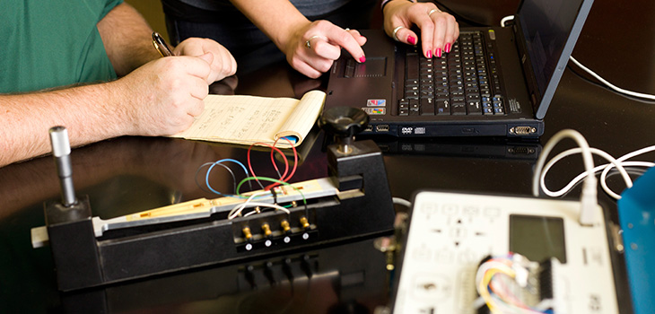 Reading data generated from equipment on a laptop screen.