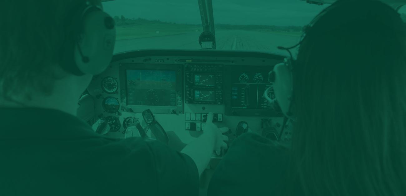 Two aviation students prep an airplane for takeoff