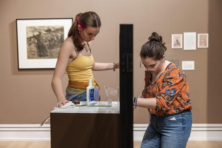 Ohio University students in the Museum Studies Certificate program curate and install an exhibit called "In These Moments" in the Kennedy Museum of Art.