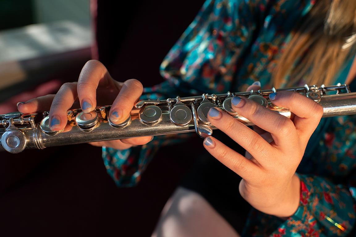 Justine Orr demonstrates various notes she can play on the flute