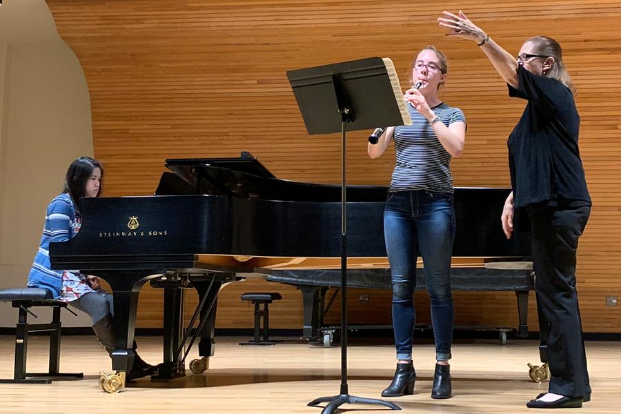 Faculty teaching students playing piano and oboe