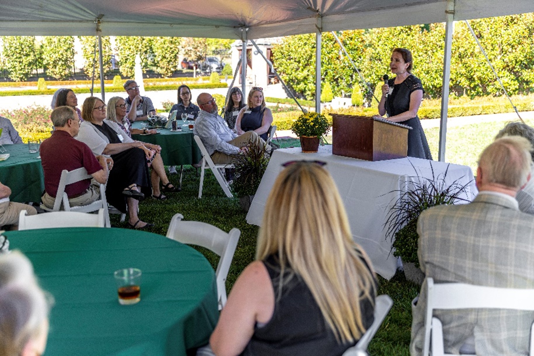 Beth Pratt giving a welcome speech at the Books, Gardens, and High Tea event