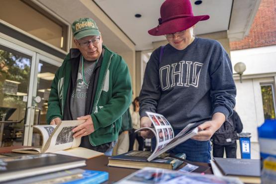 Alumni looking through yearbooks