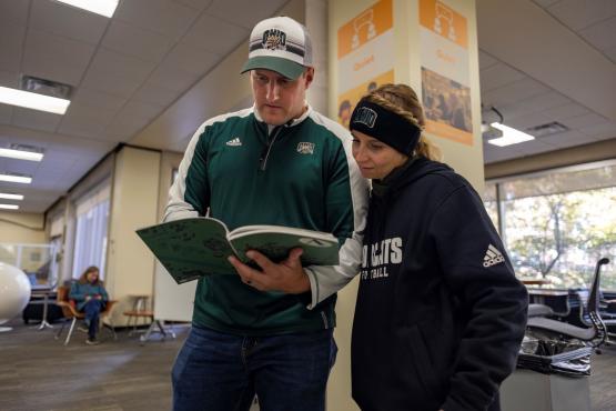 Alumni looking through yearbooks