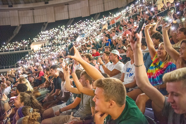 Students participate in an informal survery by holding up their cellphones at First Year Student Convocation. Photo by Ben Siegel