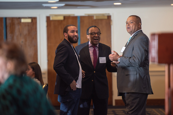 Alumni Wes Lowery (left) and Clarence Page (center) chat with Major Alston, senior associate vice president of development and campaign director.