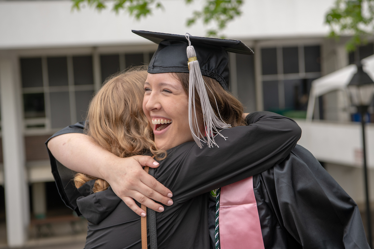 Abbey Phillips hugs friends following undergraduate commencement. Photo by Ben Siegel
