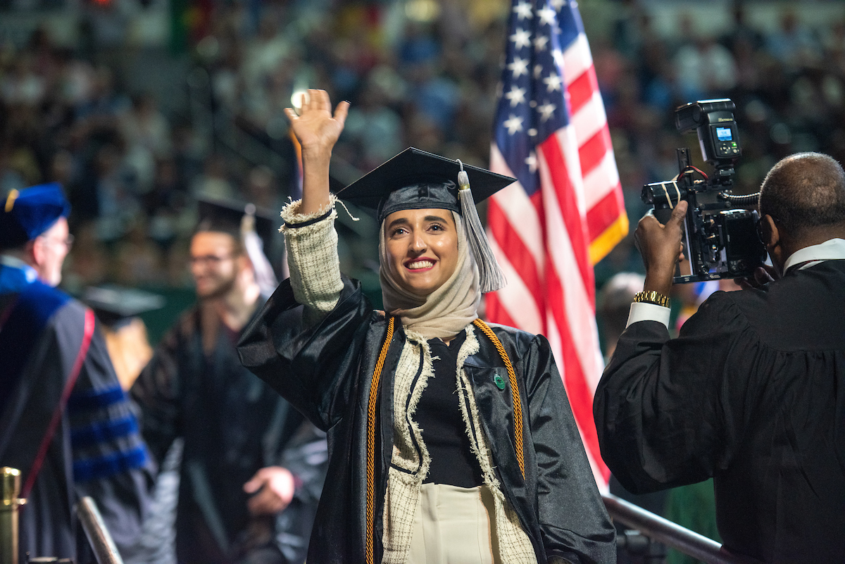 Zamam AL- Bulushi waves to supporters during Spring 2019 Undergraduate Commencement. Photo by Ben Siegel