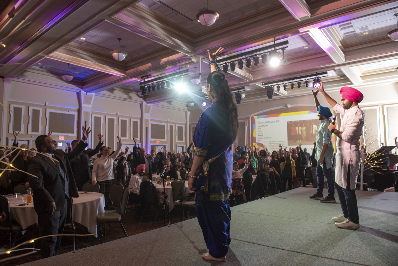 Attendees at the International Dinner participate in a dance. Photo: Hannah Ruhoff
