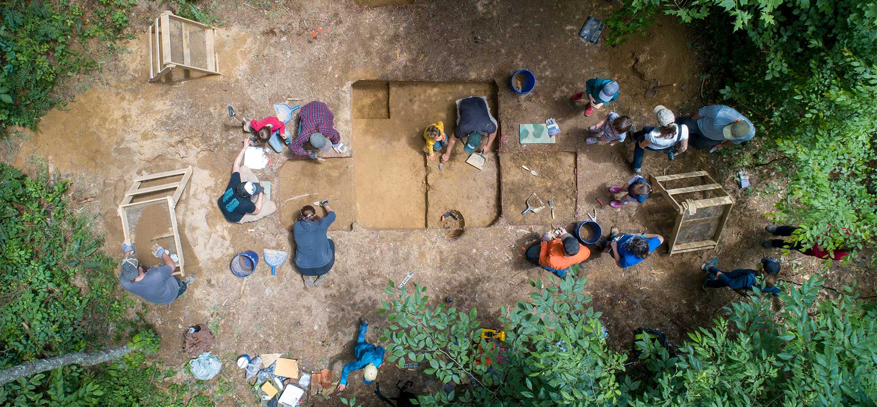 Aerial image of students and faculty with the Archaelogical Field School at a dig site