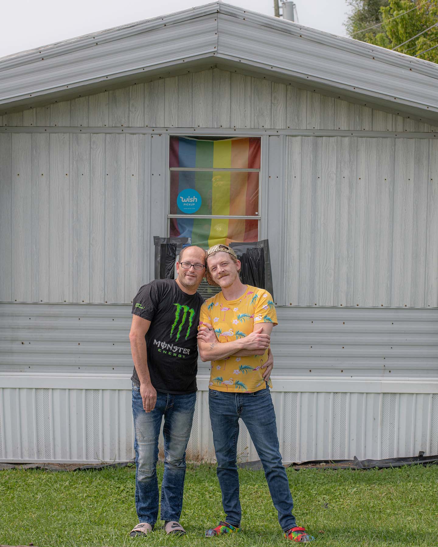 Jerry Martin and Rober Halland pose outside their residence which sports a pride flag