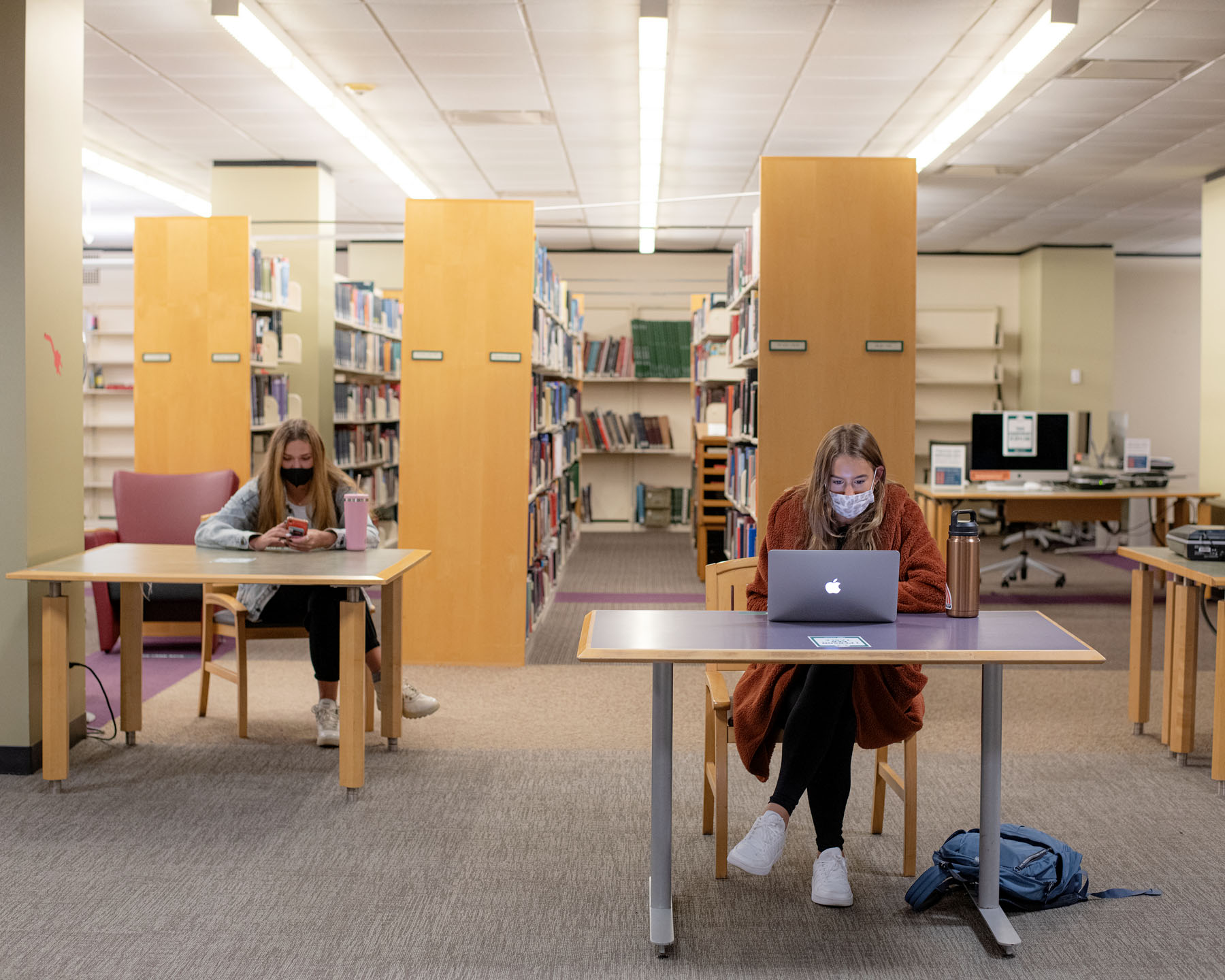 Students work in Alden library isolated from each other