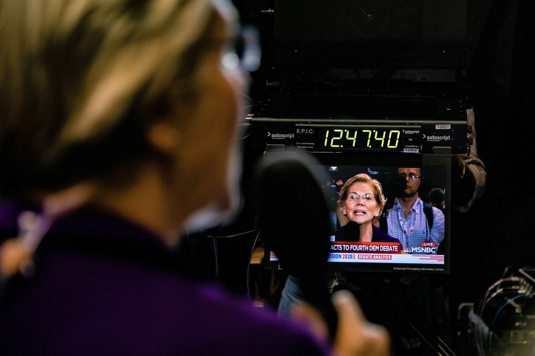 An artful portrait of Senator Elizabeth Warren doing a television segment