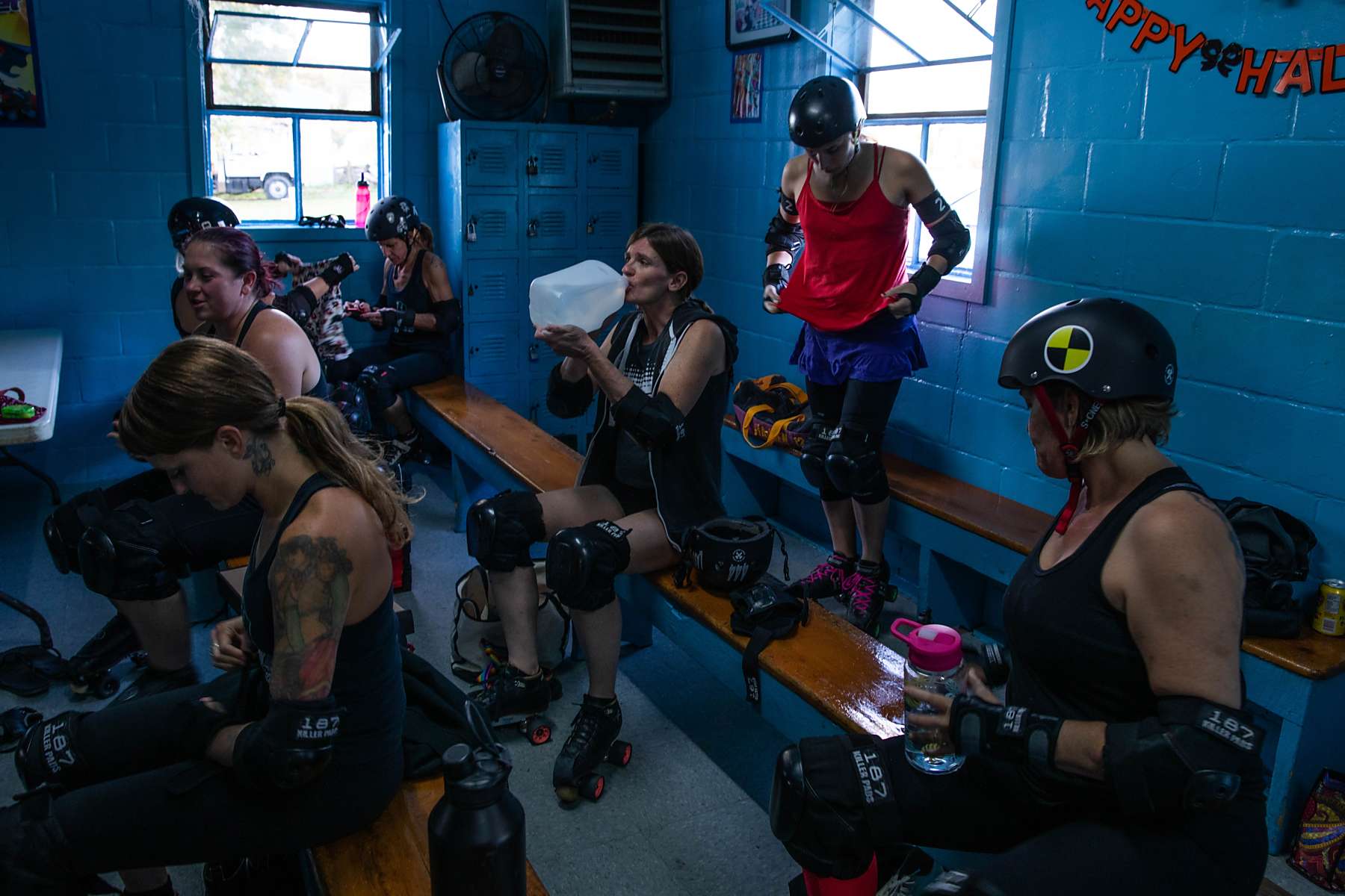 A team of women prepare for a roller derby event