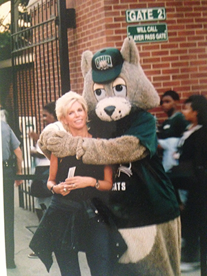 Terri Morris Stagi, BSJ ’77, poses for a photo outside of Peden Stadium with Ohio University’s mascot – before he was named Rufus and had a new look.