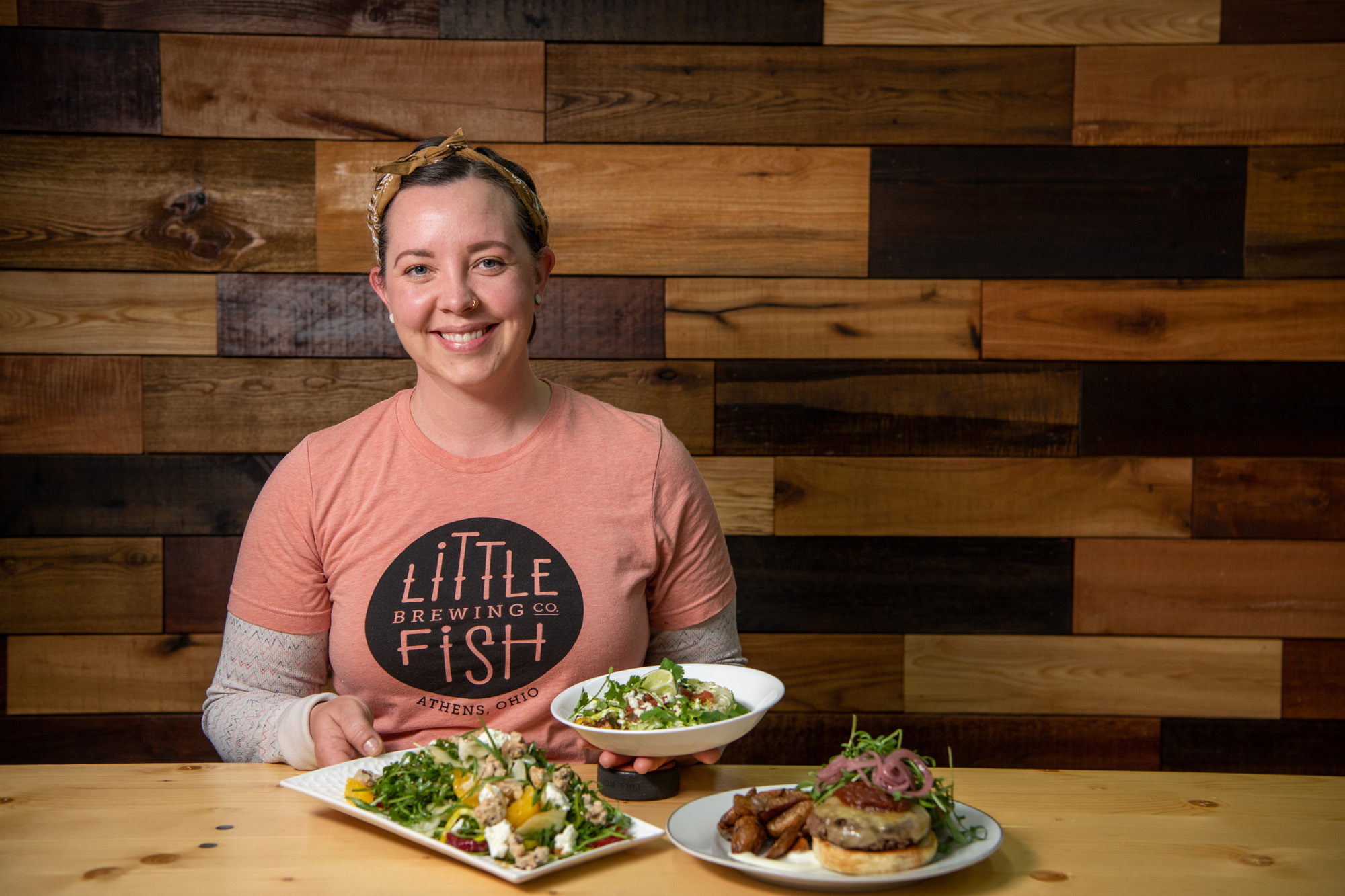 Portrait of Becky clark with fresh food from Little Fish Brewing Company