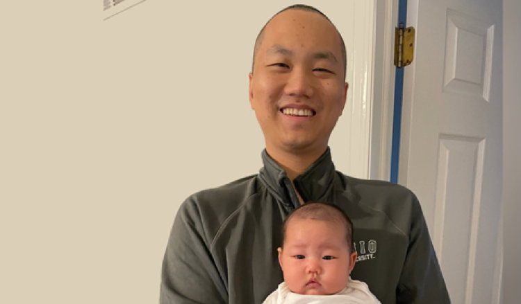 Graduate student Xianlong Zeng with baby