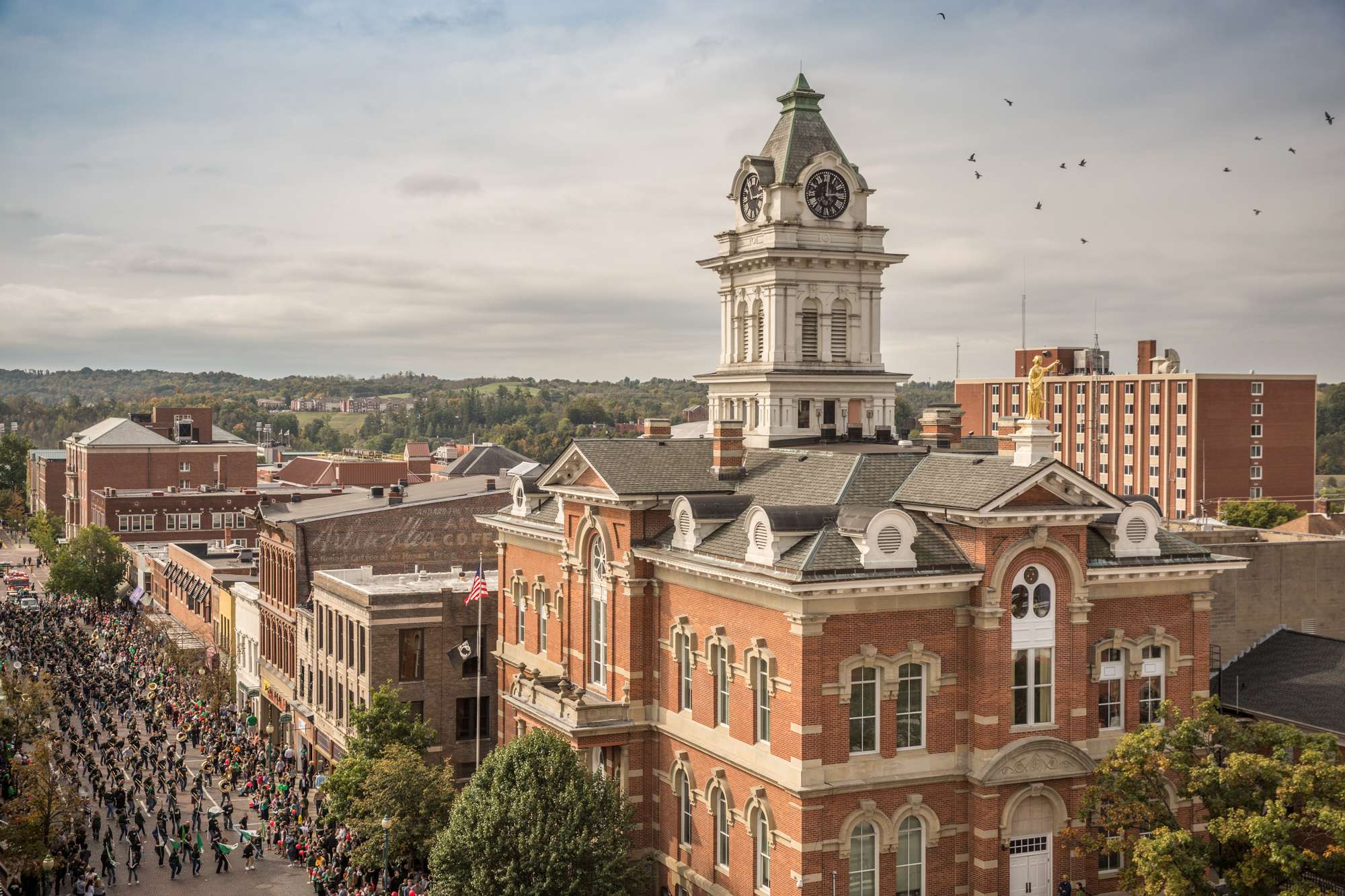 An aerial photo of Court Street in Athens, Ohio while the annual homecoming parade goes through