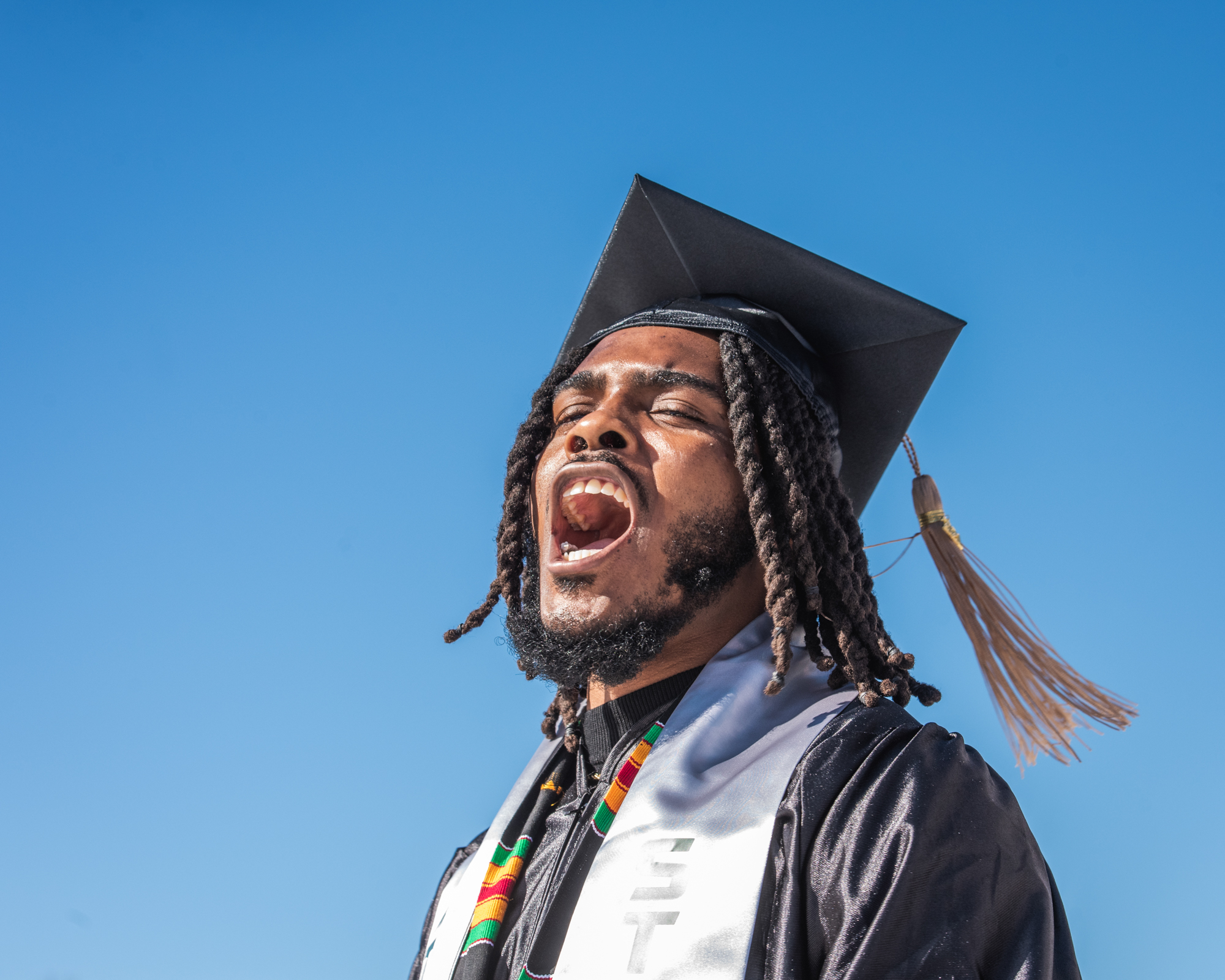 A student cheers during commencement 2021