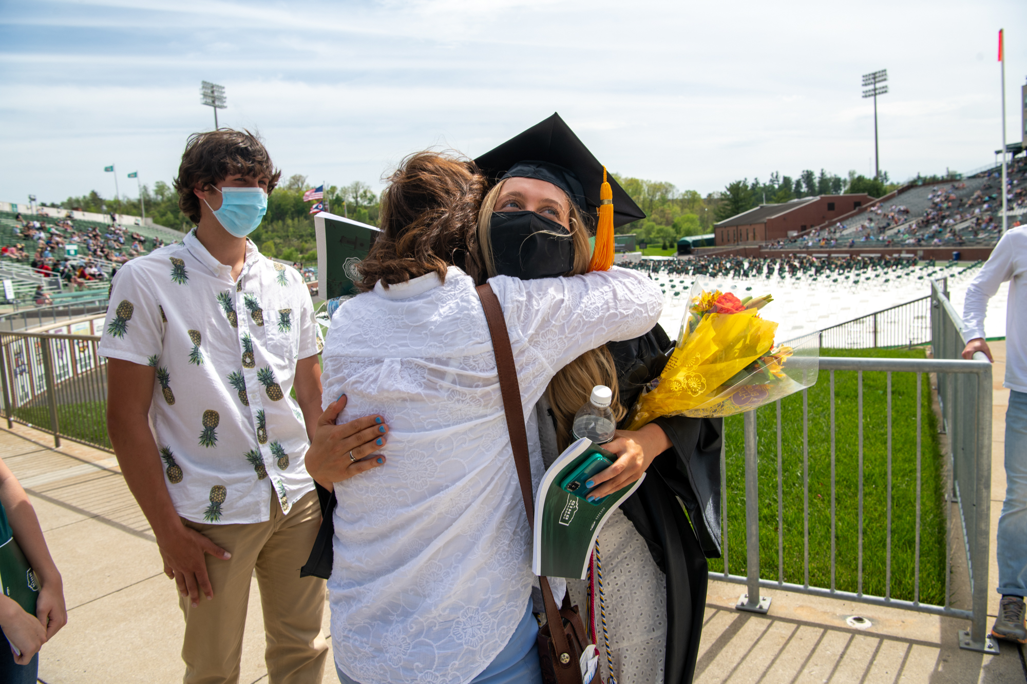 Graduating students hug their families