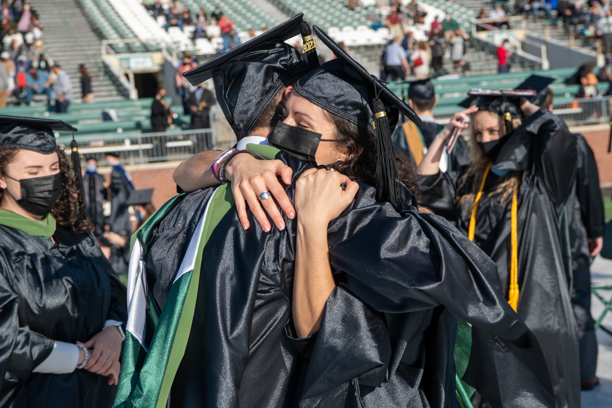 Students share a congratulatory hug during graduation day