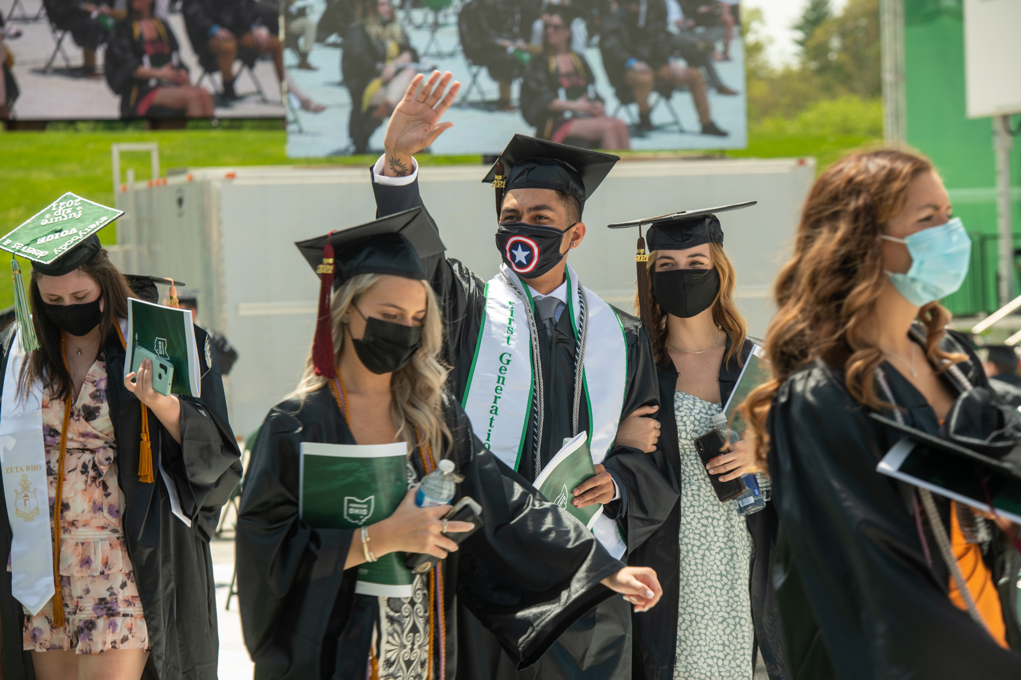 Graduating students enter the commencement ceremony with program booklets