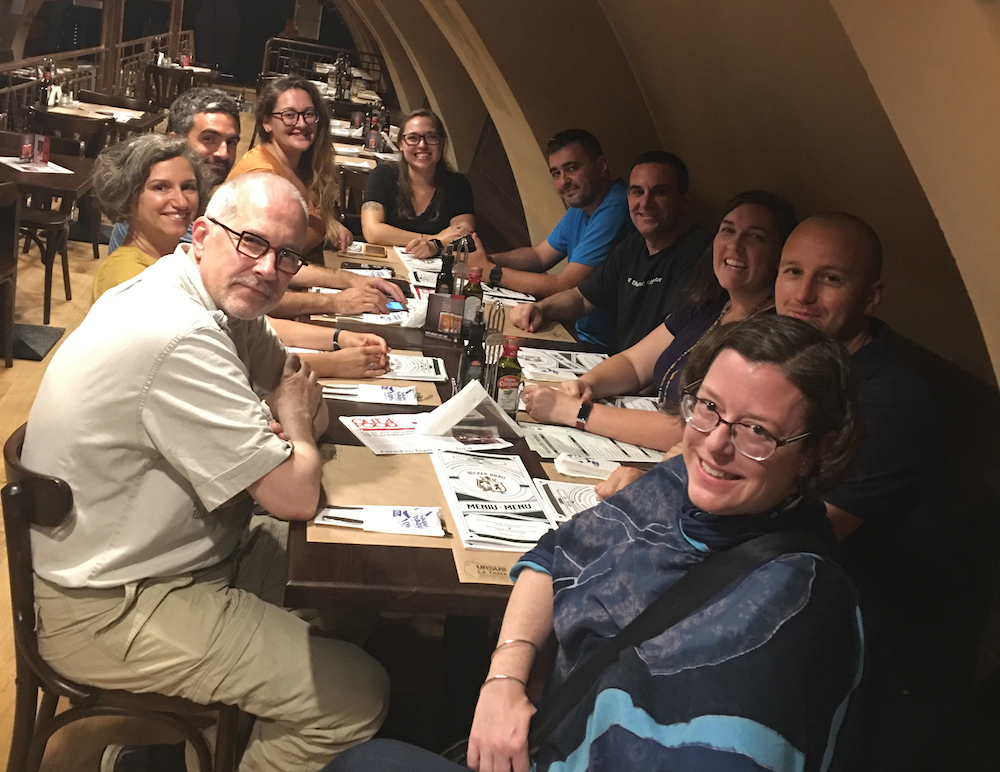 Dr. Sabrina Curran and the international team working in Romania sat around a table in a restaurant