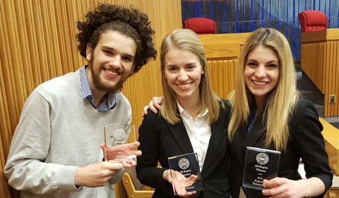 From left to right: Noah Allen, Sarah Welch, and Hannah Caldwell smile and pose, holding up their awards