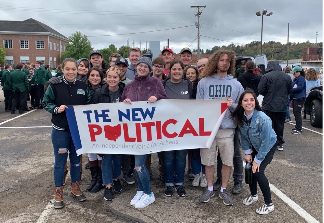 Members of The New Political prepared to walk in the Homecoming Parade at Ohio University.