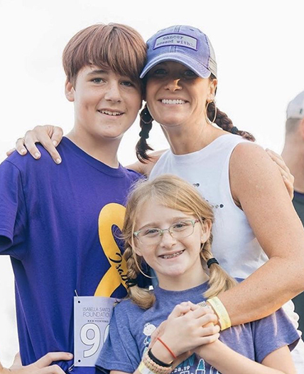 The work of the Isabella Santos Foundation is a family affair for Erin (Myers) Santos, pictured here with her children, Grant and Sophia, at one of the foundation’s annual fundraisers.