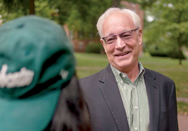 Ohio University President Hugh Sherman, who is featured on the cover of the fall 2021 issue of Ohio Today magazine, is pictured with a student on College Green.