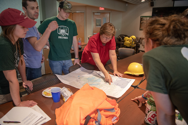 Students look at a map