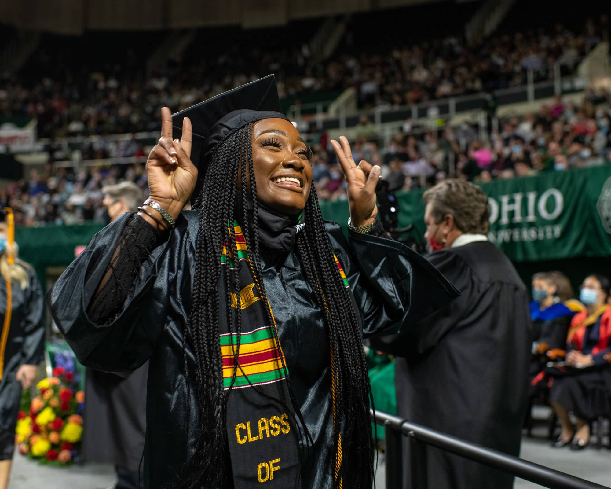 A recent graduate celebrates as she crosses the stage during the Fall Commencement 2021 at the Athens Campus.