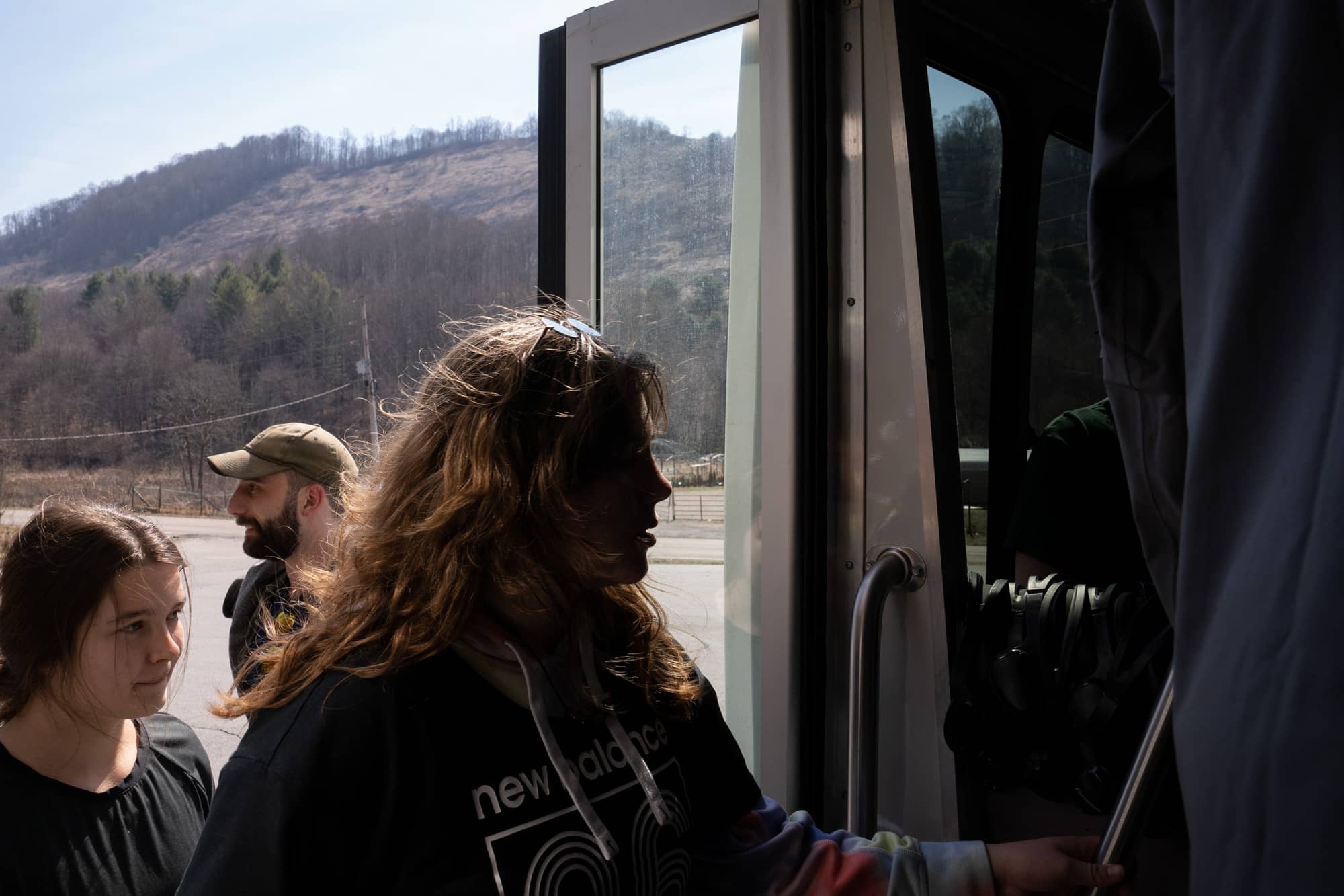 Helena Karlstrom, Riley Long and Eamonn Bell get on the bus after the last gas stop before arriving to backpack a section of the Appalachian Trail in the Nantahala National Forest on Saturday, March 5, 2022, in North Carolina.