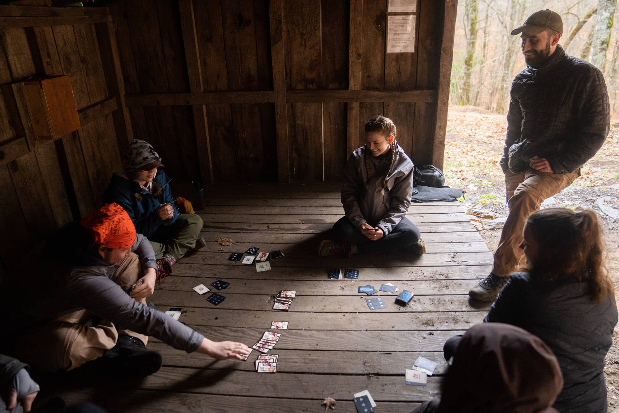 Ohio University students play cards together during their third day backpacking a section of the Appalachian Trail in the Nantahala National Forest on Monday, March 7, 2022, at the Siler Bald Shelter near Franklin, North Carolina.