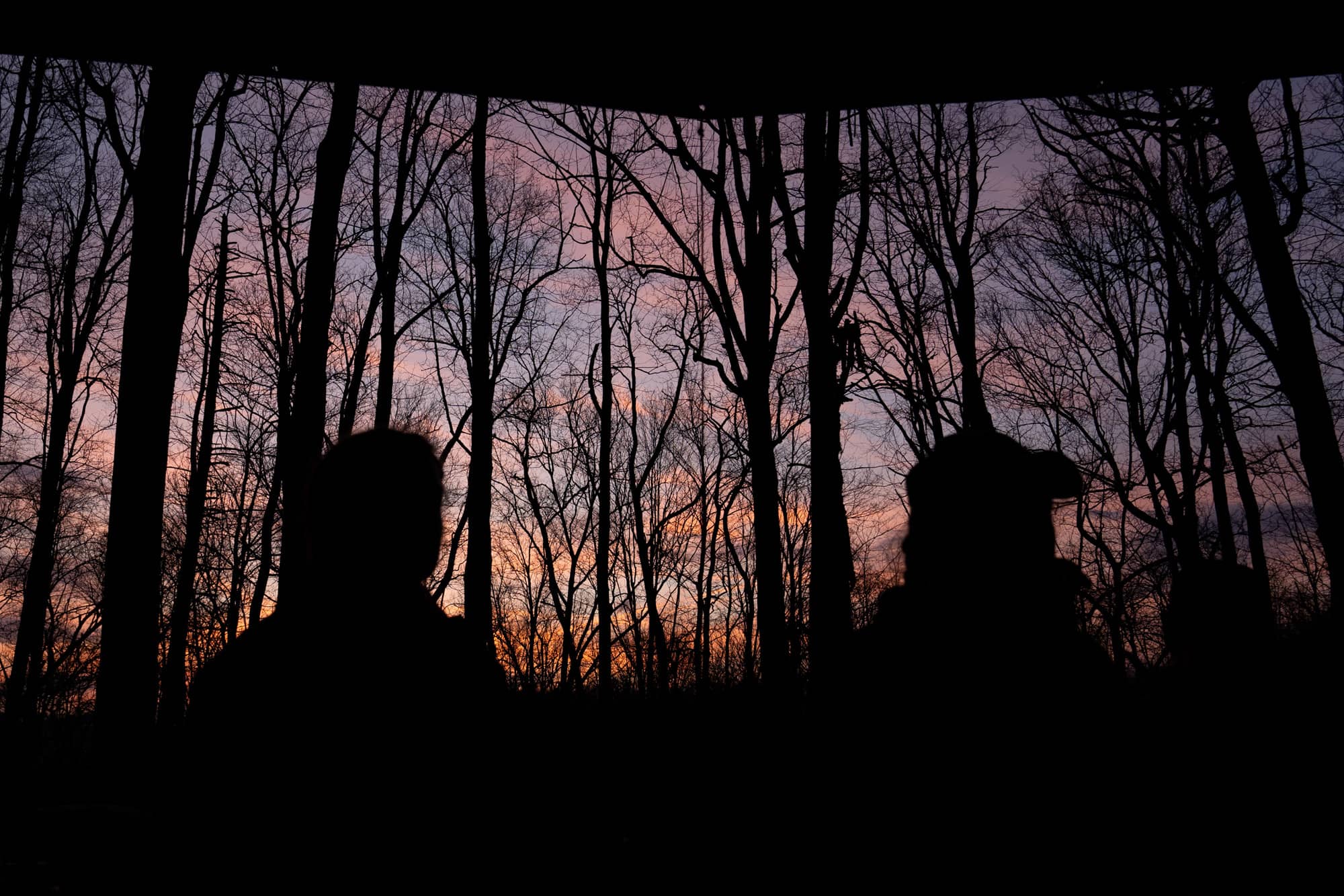 Ohio University students wait for dinner to be ready as the sun sets during their first day backpacking a section of the Appalachian Trail in the Nantahala National Forest on Saturday, March 5, 2022, at the Rock Gap Shelter near Franklin, North Carolina.