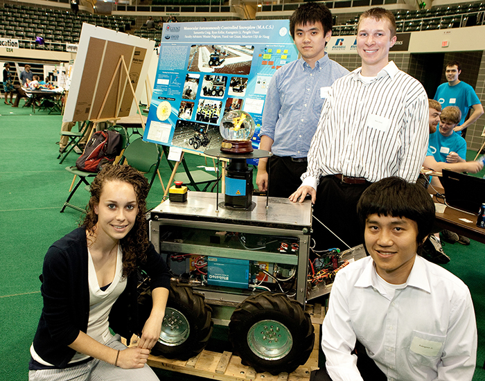 Pengfei “Phil” Duan, MS ’11, PHD ’18, is pictured at Ohio University’s 2012 Student Expo with the team of fellow engineering students with whom he constructed a robotic snowplow.
