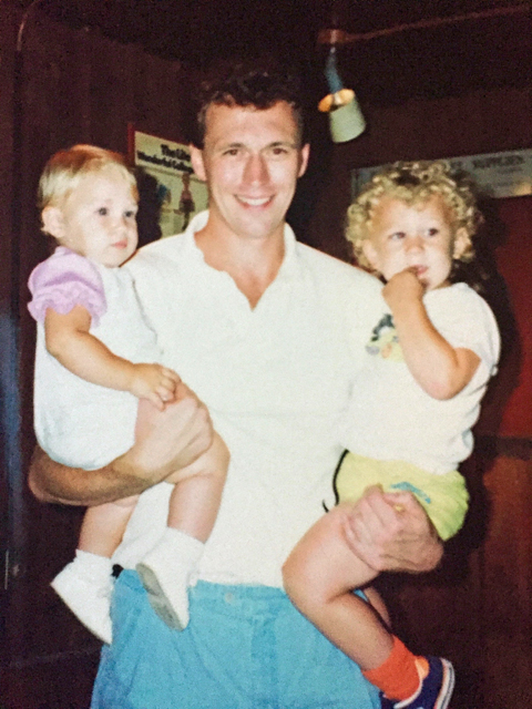 Timothy Coleman holding his daughters in Tony's Tavern