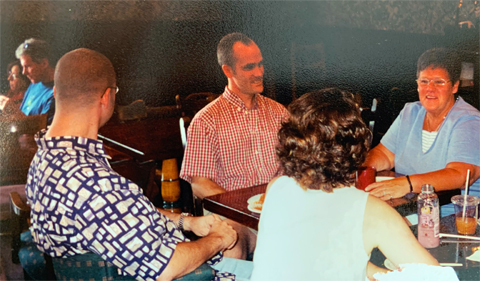 Aaron and his friends sit at a table