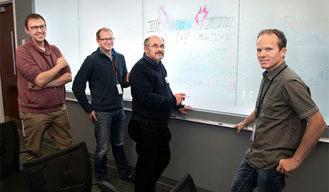 Dr. Andreas Weichselbaum and colleagues in front of a whiteboard