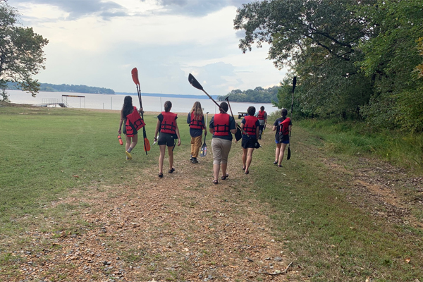 OHIO students are shown walking while getting ready to create a canoe nature trail.