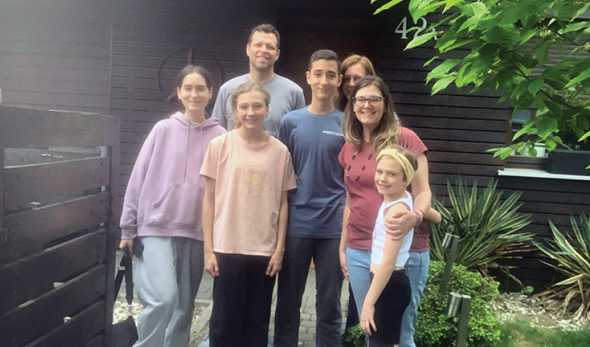 Amy Browns-Taylor and her family are pictured with the Ukrainian refugee family who lived with them for nine months.