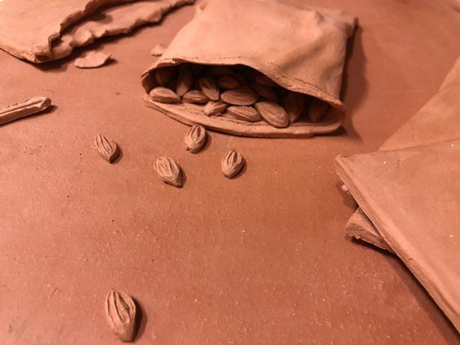 Small clay objects lightly spilling out from a larger clay object