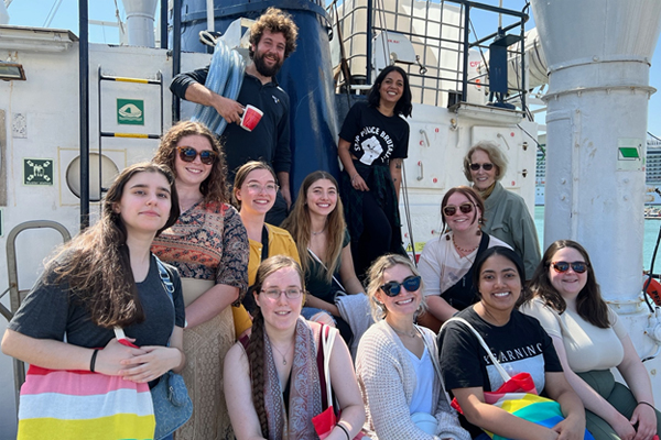 Students pose with RESQ ship volunteers in Sicily