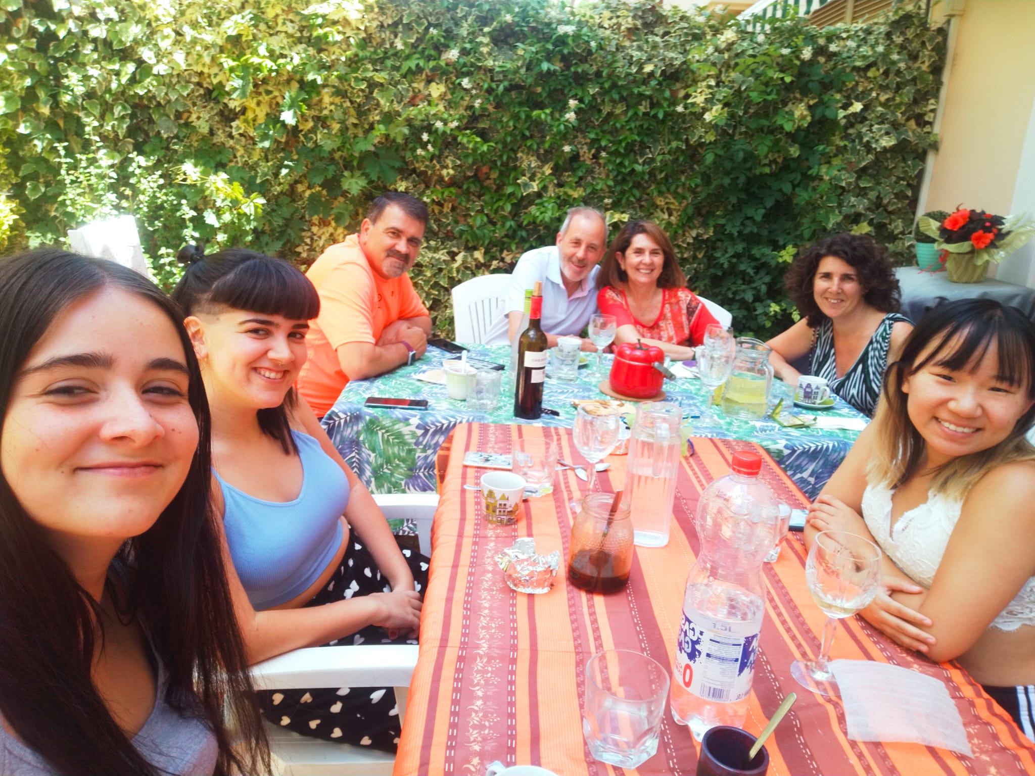 Caroline Rhude sits at a table with her host family in Spain