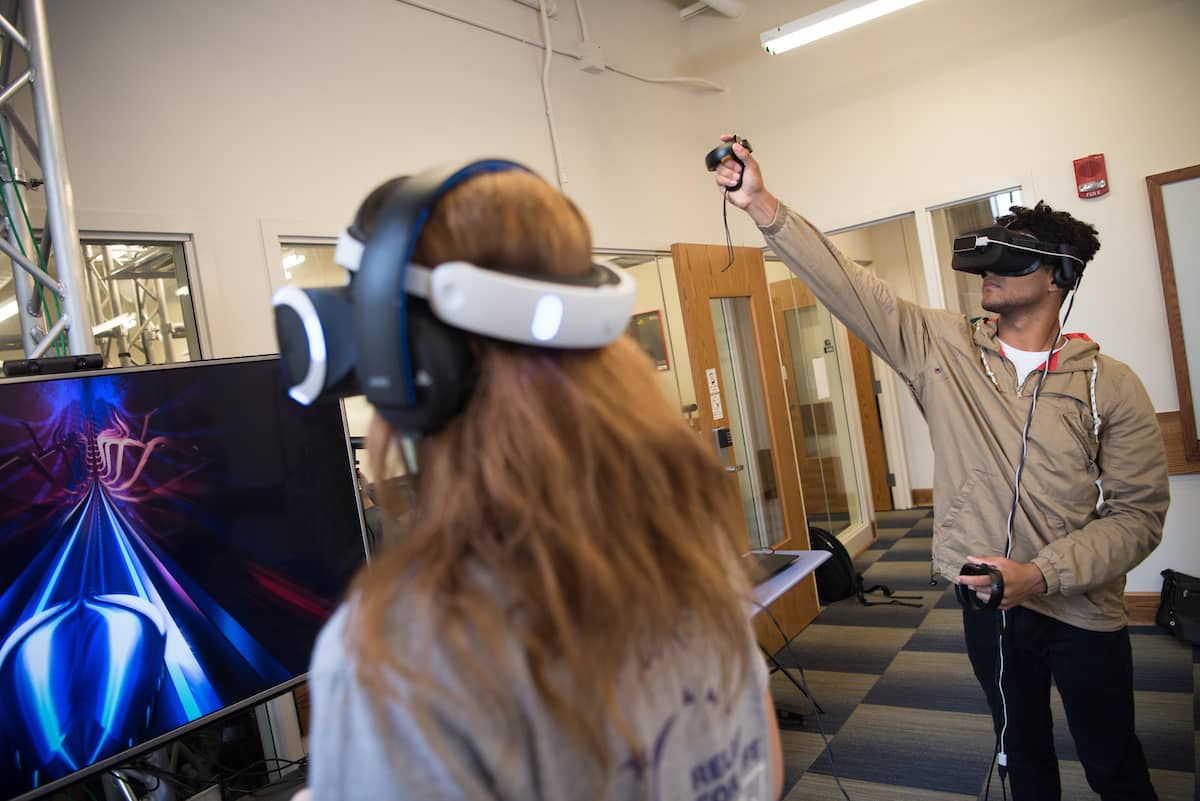 Two students using virtual reality goggles in the grid lab