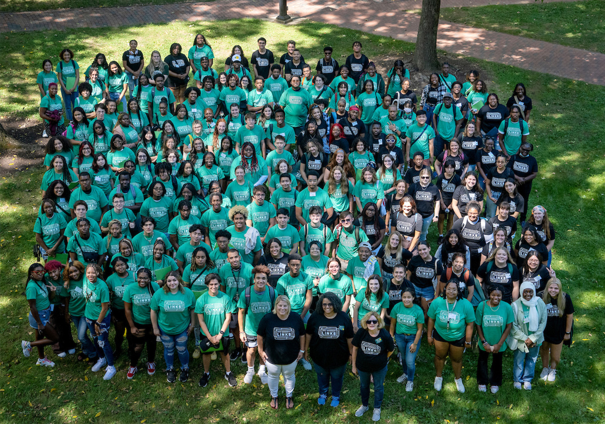 Diverse group of Ohio University students in the LINKS program poses on College green