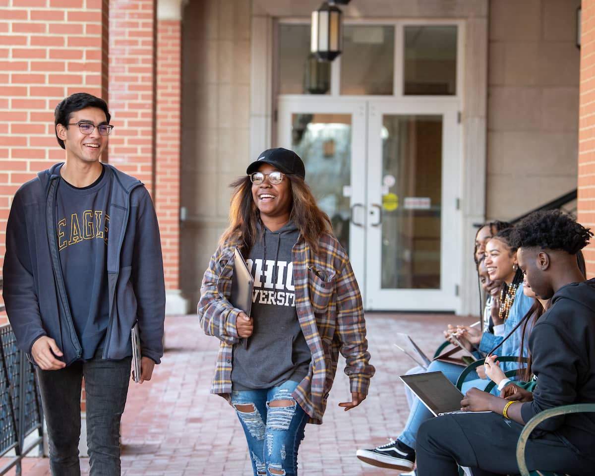 Students walking and smiling on campus
